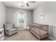 Cozy room with charming decor, crib, and comfortable chair at 1034 Fish Pond Ave, Henderson, NV 89014