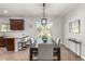 Well-lit dining area featuring a dining table with seating for eight, connecting to the kitchen at 1034 Fish Pond Ave, Henderson, NV 89014