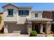 Charming two-story home featuring a stone-accented entrance, a well-kept lawn, and a two-car garage at 1034 Fish Pond Ave, Henderson, NV 89014