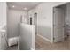 Bright upstairs hallway with carpet flooring and multiple entryways at 1034 Fish Pond Ave, Henderson, NV 89014