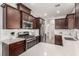 Modern kitchen featuring dark cabinets, white countertops, and stainless steel appliances at 1034 Fish Pond Ave, Henderson, NV 89014