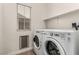 Bright laundry room with modern washer and dryer at 1034 Fish Pond Ave, Henderson, NV 89014
