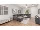 Bright living room featuring a comfortable sectional sofa, tile flooring, and ample natural light at 1034 Fish Pond Ave, Henderson, NV 89014