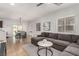Open-concept living area with a sectional sofa, adjacent to a dining space, perfect for modern living at 1034 Fish Pond Ave, Henderson, NV 89014