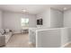 Neutral colored loft with carpet, natural light, couch, and table at 1034 Fish Pond Ave, Henderson, NV 89014