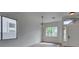Bright living room with a view to the front yard through large windows at 10452 Niagara Falls Ln, Las Vegas, NV 89144