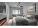 Beautifully staged main bedroom featuring a fireplace, ceiling fan, and scenic window view at 10452 Niagara Falls Ln, Las Vegas, NV 89144
