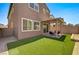 Large backyard featuring ample green space and a covered patio with outdoor seating at 10650 Dryades Ave, Las Vegas, NV 89166