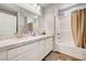 Clean bathroom featuring double vanity sinks, a shower over tub, and modern lighting at 10650 Dryades Ave, Las Vegas, NV 89166