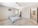 Bright bedroom featuring a ceiling fan, carpet, window, and decorative mirror at 10650 Dryades Ave, Las Vegas, NV 89166