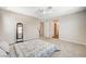 Spacious bedroom featuring neutral walls, carpet, ceiling fan, and decorative mirror at 10650 Dryades Ave, Las Vegas, NV 89166
