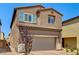 Two-story home featuring a two-car garage and easy-care desert landscaping on a sunny day at 10650 Dryades Ave, Las Vegas, NV 89166