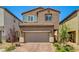 Charming two-story home with a two-car garage and desert landscaping in a sunny neighborhood at 10650 Dryades Ave, Las Vegas, NV 89166