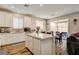 Modern kitchen with sleek white cabinets, stainless steel appliances, and a center island at 10650 Dryades Ave, Las Vegas, NV 89166