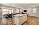 Open concept living area with island, dining space, and a view to the backyard patio at 10650 Dryades Ave, Las Vegas, NV 89166
