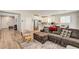 Comfortable living room with wood-look floors, leading to the bright kitchen and dining areas at 10650 Dryades Ave, Las Vegas, NV 89166