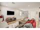 Well-lit living room features wood-look flooring with a view of the open floor plan at 10650 Dryades Ave, Las Vegas, NV 89166