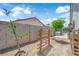 Backyard area with plenty of sunlight, mature trees, and privacy wall ready for your personal touch at 1105 Winwood St, Las Vegas, NV 89108