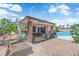 Spacious backyard featuring a covered patio, refreshing pool, and ample space for outdoor entertaining at 1105 Winwood St, Las Vegas, NV 89108