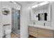 Modern bathroom featuring a double vanity, walk-in glass shower with tile surround and updated fixtures at 1105 Winwood St, Las Vegas, NV 89108