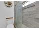 Updated bathroom with glass enclosed shower that features gray tile and a built-in shower caddy at 1105 Winwood St, Las Vegas, NV 89108