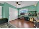 Bright bedroom features wood floors, ceiling fan, large window and closet at 1105 Winwood St, Las Vegas, NV 89108
