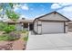 Charming single-story home with a well-maintained front yard and a two-car garage at 1105 Winwood St, Las Vegas, NV 89108