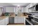 Well-lit kitchen with white cabinets, stainless appliances and a view from the sink window at 1105 Winwood St, Las Vegas, NV 89108