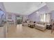 Spacious living room featuring tile floors, a large sectional sofa, and sliding door access at 1105 Winwood St, Las Vegas, NV 89108