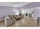 Open-concept living room and kitchen area with neutral colors and ample natural light at 1105 Winwood St, Las Vegas, NV 89108
