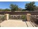 Inviting back patio featuring a stone retaining wall and wrought iron railing at 1177 Twinkling Meadows Dr, Henderson, NV 89012