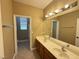 Bright bathroom featuring dual sinks and a large mirror at 1177 Twinkling Meadows Dr, Henderson, NV 89012