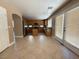 Open kitchen featuring wood cabinets and stainless steel appliances, tile floor, and patio access at 1177 Twinkling Meadows Dr, Henderson, NV 89012