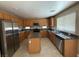 Bright kitchen with stainless steel appliances, granite countertops, and an island at 1177 Twinkling Meadows Dr, Henderson, NV 89012