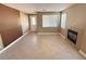 Open living room featuring a fireplace, large windows, and neutral tile flooring at 1177 Twinkling Meadows Dr, Henderson, NV 89012