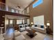 Bright living room with high ceilings, a loft overlook, comfortable furnishings and plenty of natural light at 1177 Twinkling Meadows Dr, Henderson, NV 89012