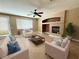 Comfortable living room with a fireplace, ceiling fan, and neutral decor at 1177 Twinkling Meadows Dr, Henderson, NV 89012