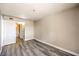 This bedroom has light grey walls, wood-look flooring, and access to the bathroom at 1381 E University Ave # 204, Las Vegas, NV 89119