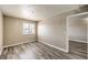 A bright bedroom with a large window and wood-look flooring throughout at 1381 E University Ave # 204, Las Vegas, NV 89119