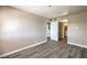 A large bedroom with wood-look flooring, leading to a bathroom at 1381 E University Ave # 204, Las Vegas, NV 89119