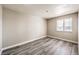 A bright bedroom with a large window and wood-look flooring throughout at 1381 E University Ave # 204, Las Vegas, NV 89119