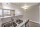 The kitchen features a double sink and a countertop bar overlooking the living room at 1381 E University Ave # 204, Las Vegas, NV 89119
