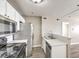 Modern kitchen features a double sink, stainless steel refrigerator, and laminate floors at 1381 E University Ave # 204, Las Vegas, NV 89119