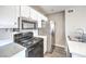 The kitchen features stainless steel appliances and white cabinets and modern countertops at 1381 E University Ave # 204, Las Vegas, NV 89119