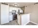 The kitchen is fully equipped with appliances and white cabinets and bar seating at 1381 E University Ave # 204, Las Vegas, NV 89119