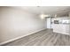 The living room features laminate floors, a view of the kitchen, and neutral walls at 1381 E University Ave # 204, Las Vegas, NV 89119