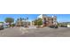 Exterior view of a multi-story condo building, featuring ample parking spaces and desert landscaping at 1381 E University Ave # 204, Las Vegas, NV 89119
