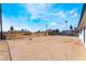 View of the spacious backyard with potential for landscaping and outdoor activities under a bright, blue sky at 1648 J St, Las Vegas, NV 89106