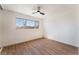 Clean bedroom with wood flooring, a ceiling fan, and plenty of natural light at 1648 J St, Las Vegas, NV 89106