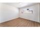 Well-lit bedroom featuring hardwood floors and a window with blinds at 1648 J St, Las Vegas, NV 89106